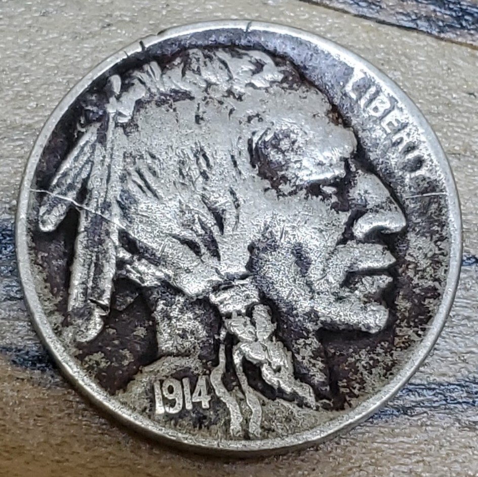 1914 Buffalo Nickel die clash error showing ghost impression of E PLURIBUS UNUM lettering in the obverse field near the Indian portrait